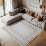 Boutique-05 cream and beige bordered rug in luxury living room with large sectional and warm lighting