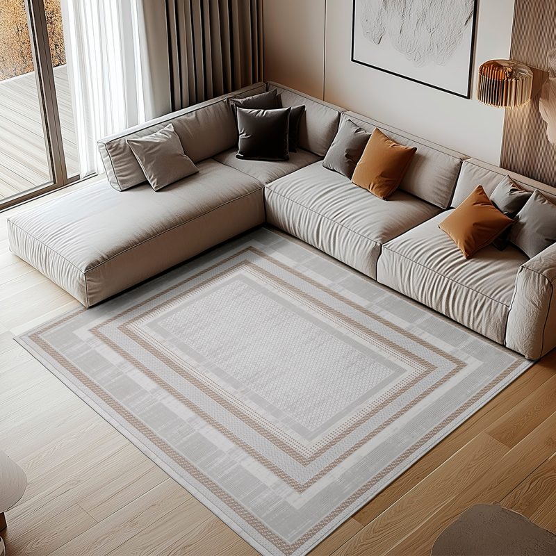 Boutique-05 cream and beige bordered rug in luxury living room with large sectional and warm lighting